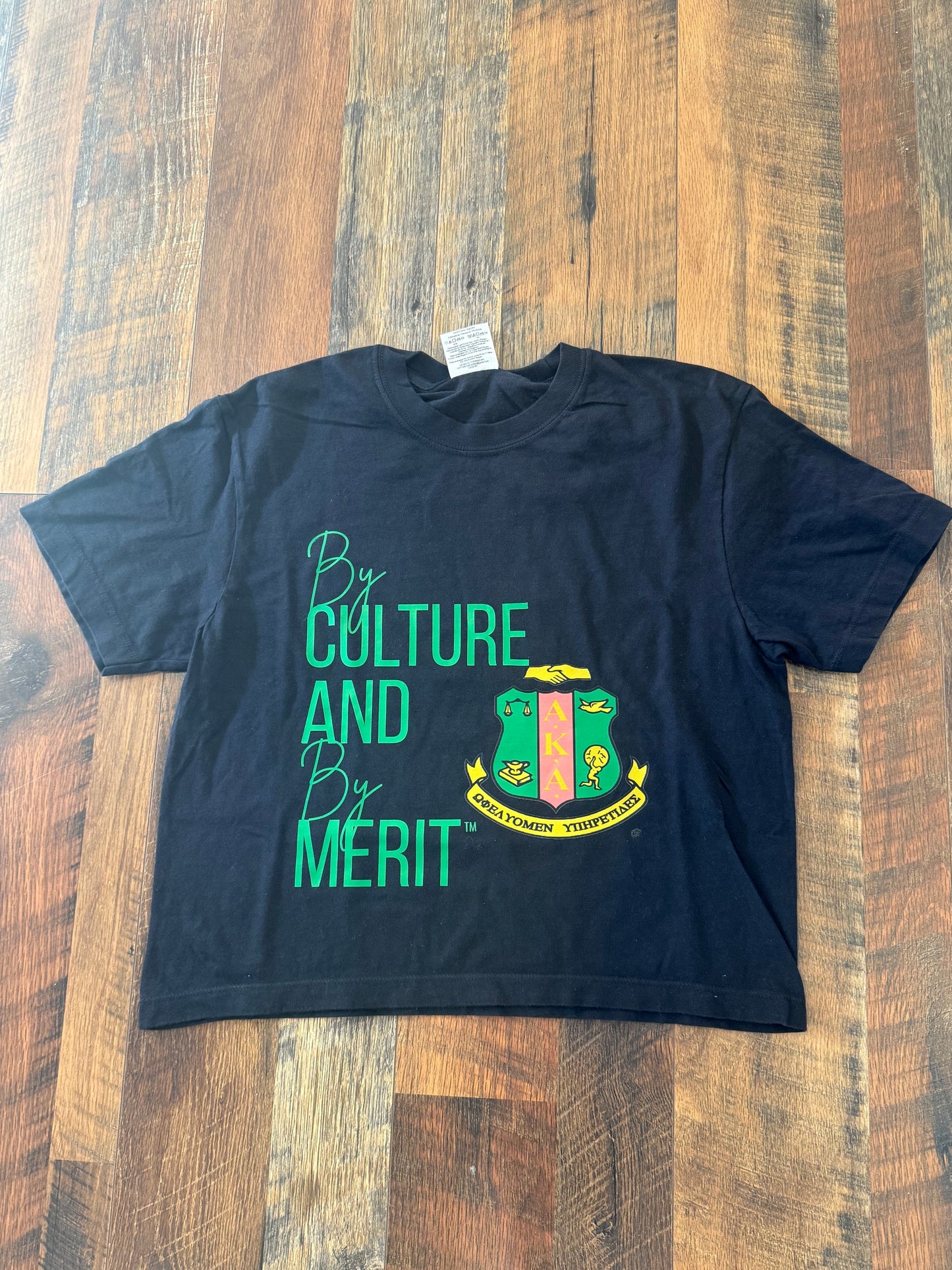 By culture and by merit T-shirt